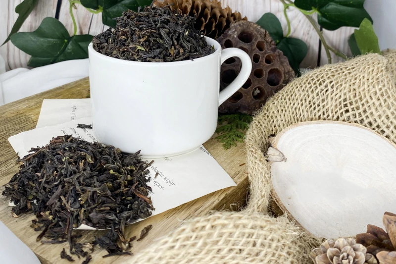 Zbliżenie na wysokiej jakości liście herbat Assam Darjeeling oraz Ceylon ze złocistymi pączkami